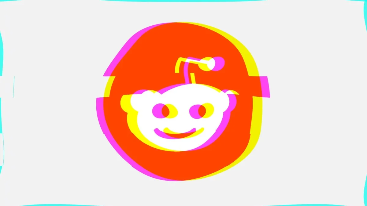 The Reddit logo, a white alien head on an orange-red circle, drawn with a glitch effect: pink and yellow copies of the shape are shifted sideways and the circle is cut by horizontal offsets, on a light gray background.
